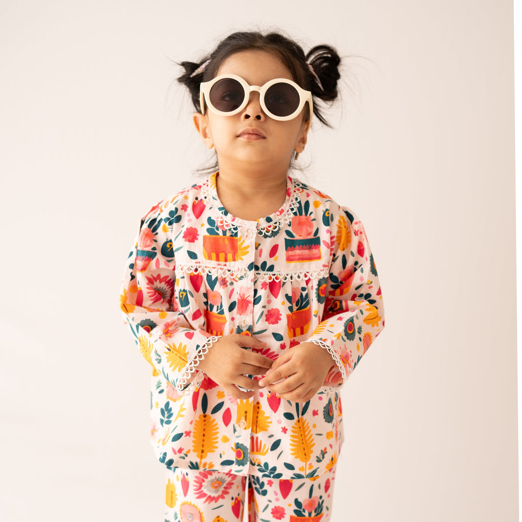 Child wearing a colorful pajama set with a white background